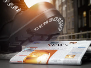 Media censorship and right of freedom of speech concept. Boot with text censorship and pile of newspaper. 