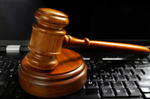 judges wooden gavel court gavel on a laptop computer (cyber law)