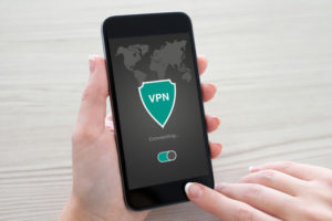 man holding phone with app vpn creation Internet protocols for protection private network