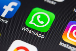 WhatsApp messenger application icon on Apple iPhone 8 smartphone screen close-up. WhatsApp messenger app icon. Social media app. Social network