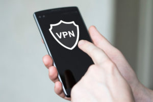 man pressing button app vpn creation Internet protocols for protection private network on phone.