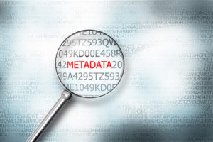 reading word metadata on digital computer screen with a magnifying glass internet security