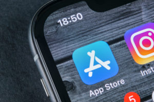 Apple store application icon on Apple iPhone X smartphone screen close-up.