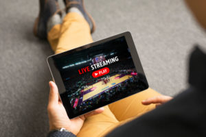Man watching sports on live streaming online servic